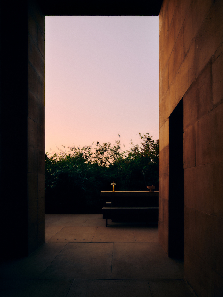 A sunset seen through an open door of a home