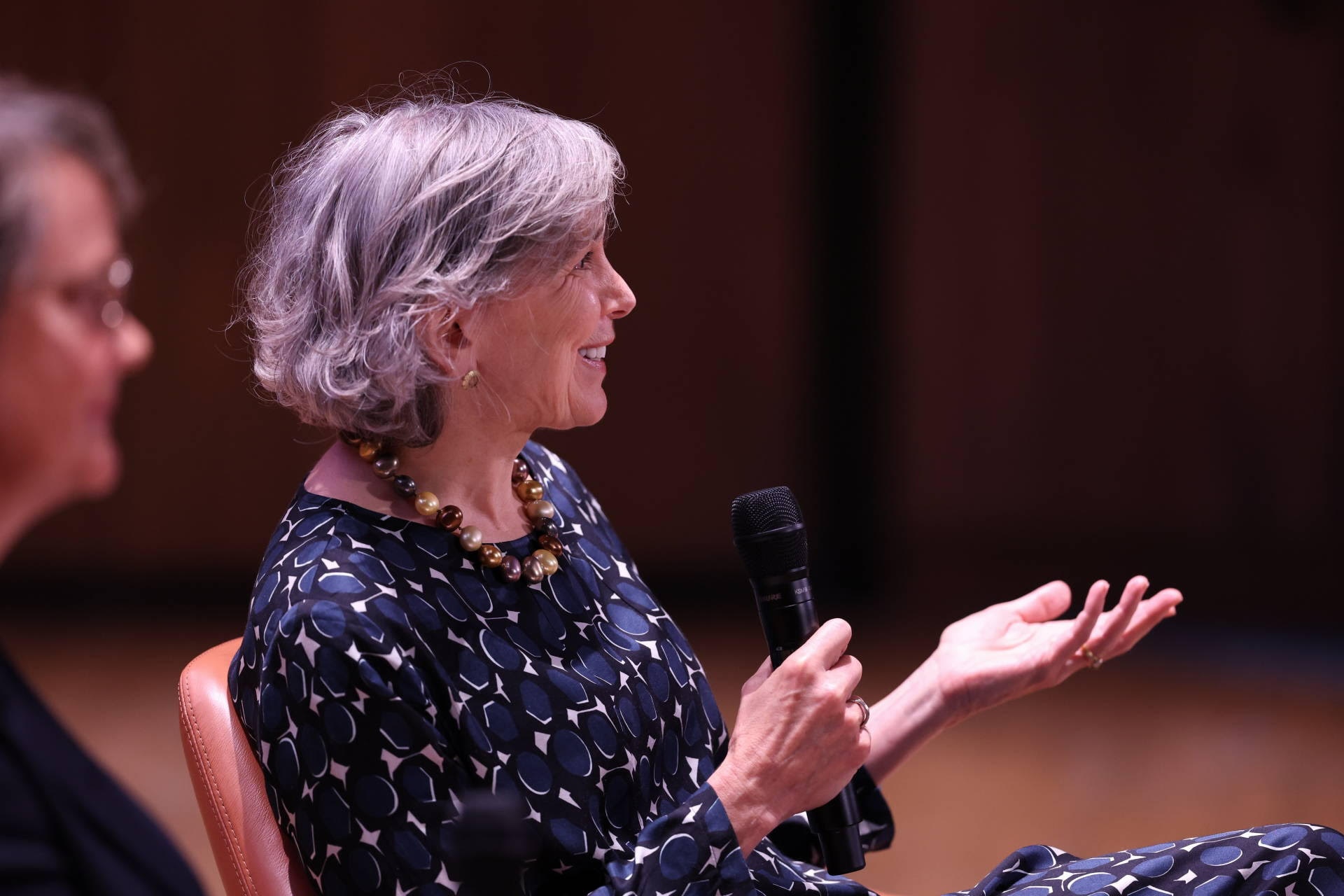 Close-up side view of Sarah Williams Goldhagen speaking into microphone at the 2023 Intentional Spaces Summit