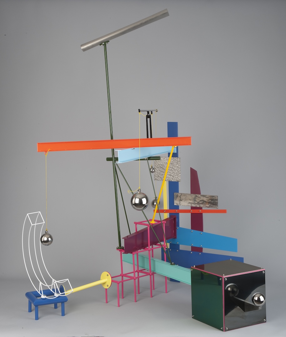 Sculpture by Peter Shire of many different shapes and colors against gray background