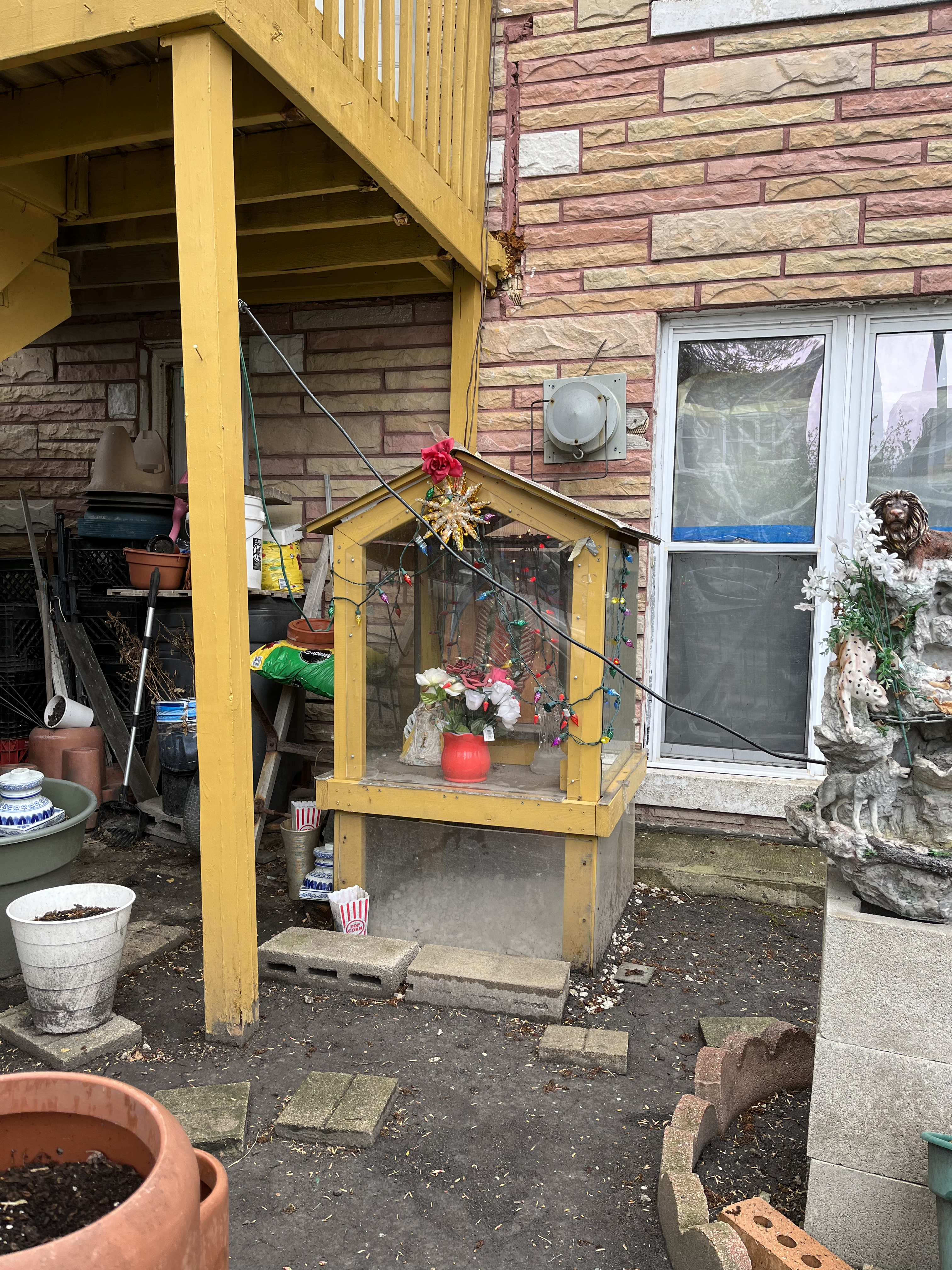 A makeshift chapel under a wooden deck