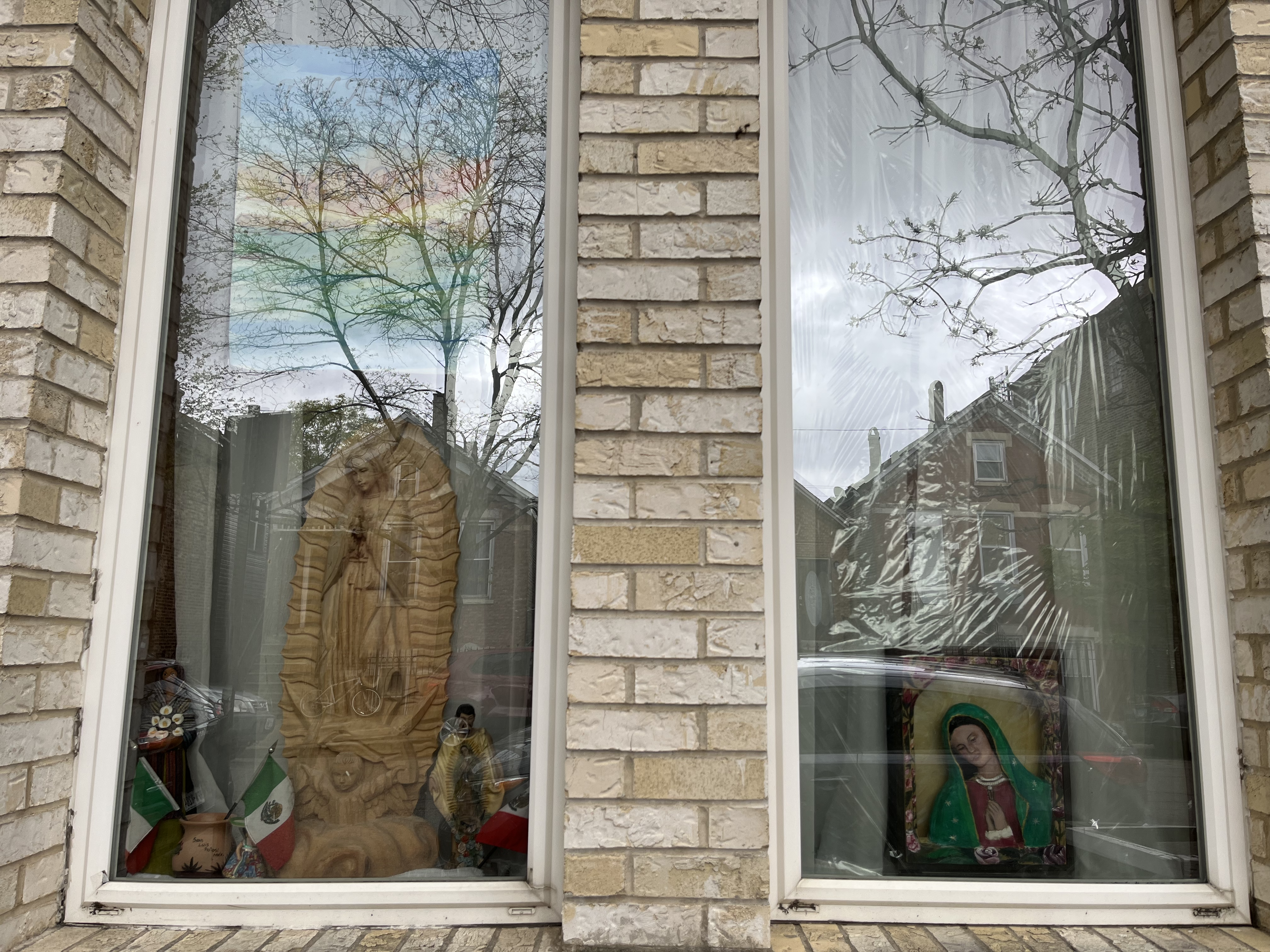 A window with religious figurines in it. 