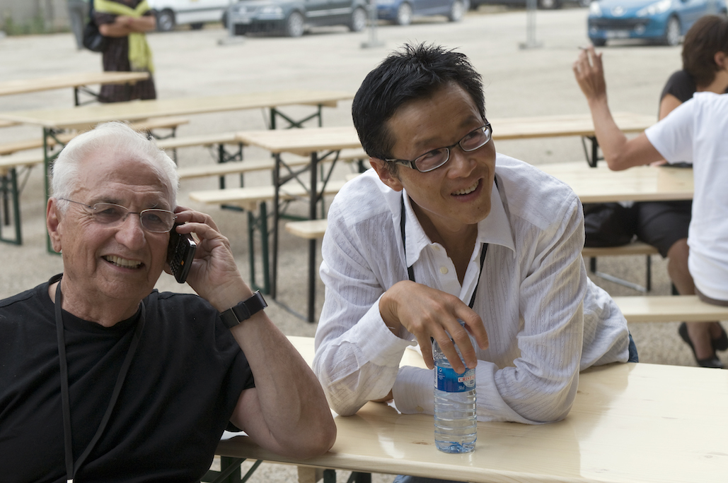 Architects Frank Gehry and Edwin Chan at a table outside