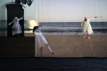 Mixed media artwork of three women spread out on a beach in white dresses