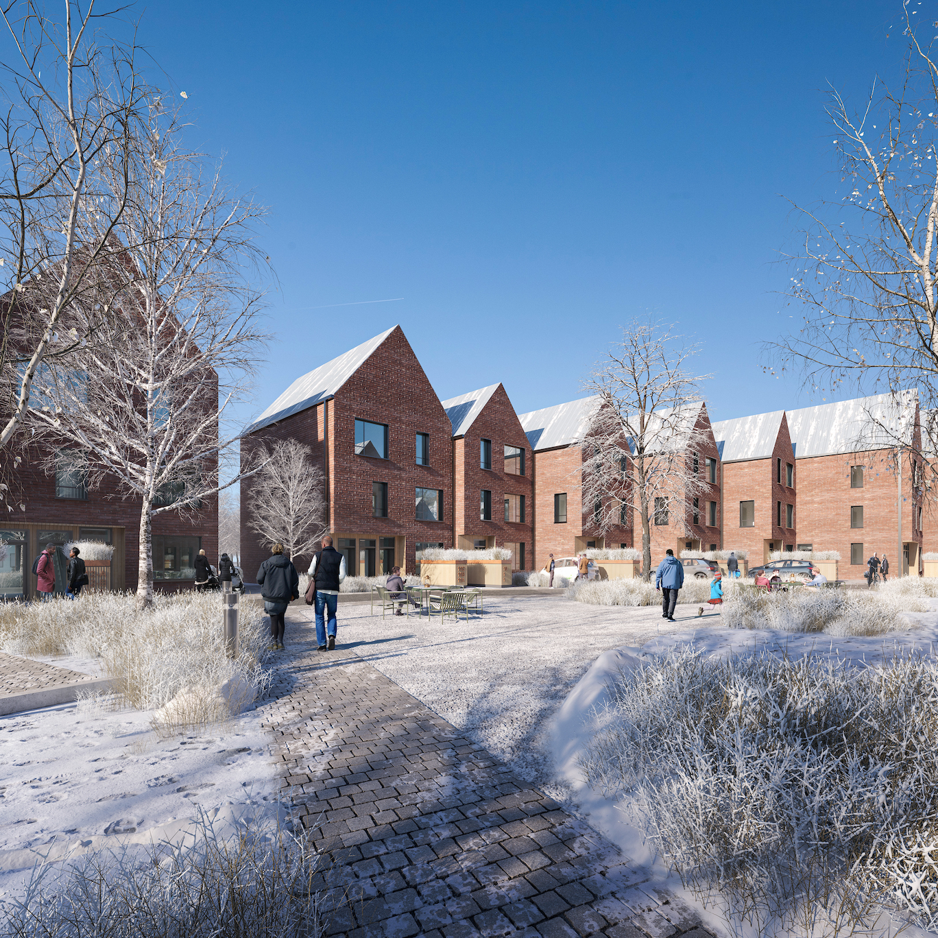 A row of brick buildings against a blue skin in the snow