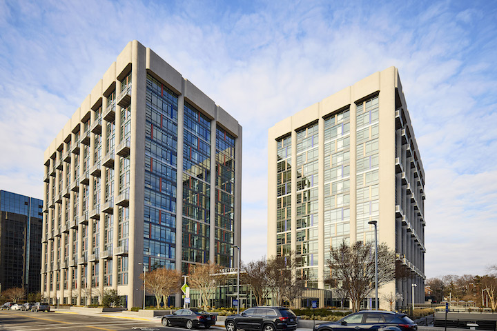 Street view of two tall commercial buildings that have been turned into housing