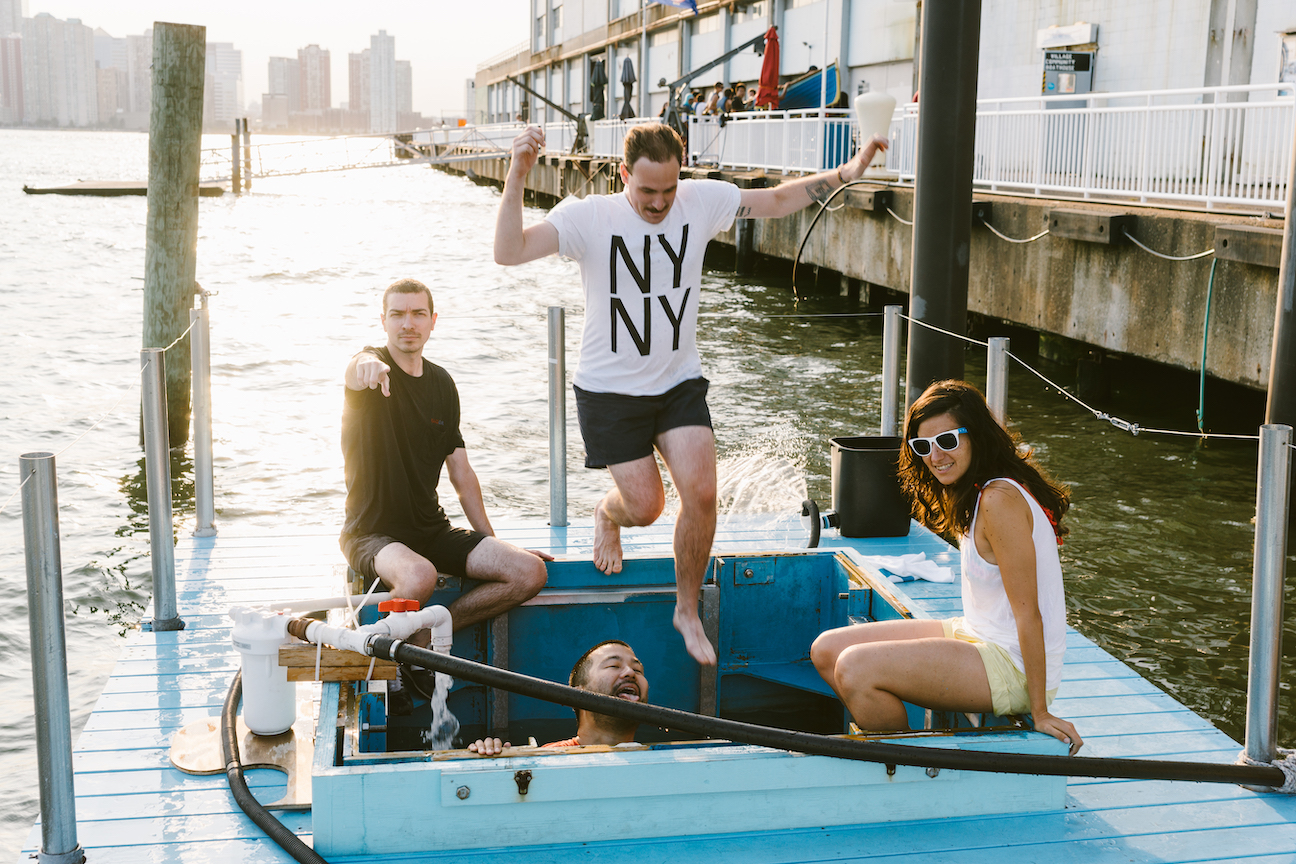 Four young adults hanging out and posing for a picture on the Plus Pool Float Lab in 2014