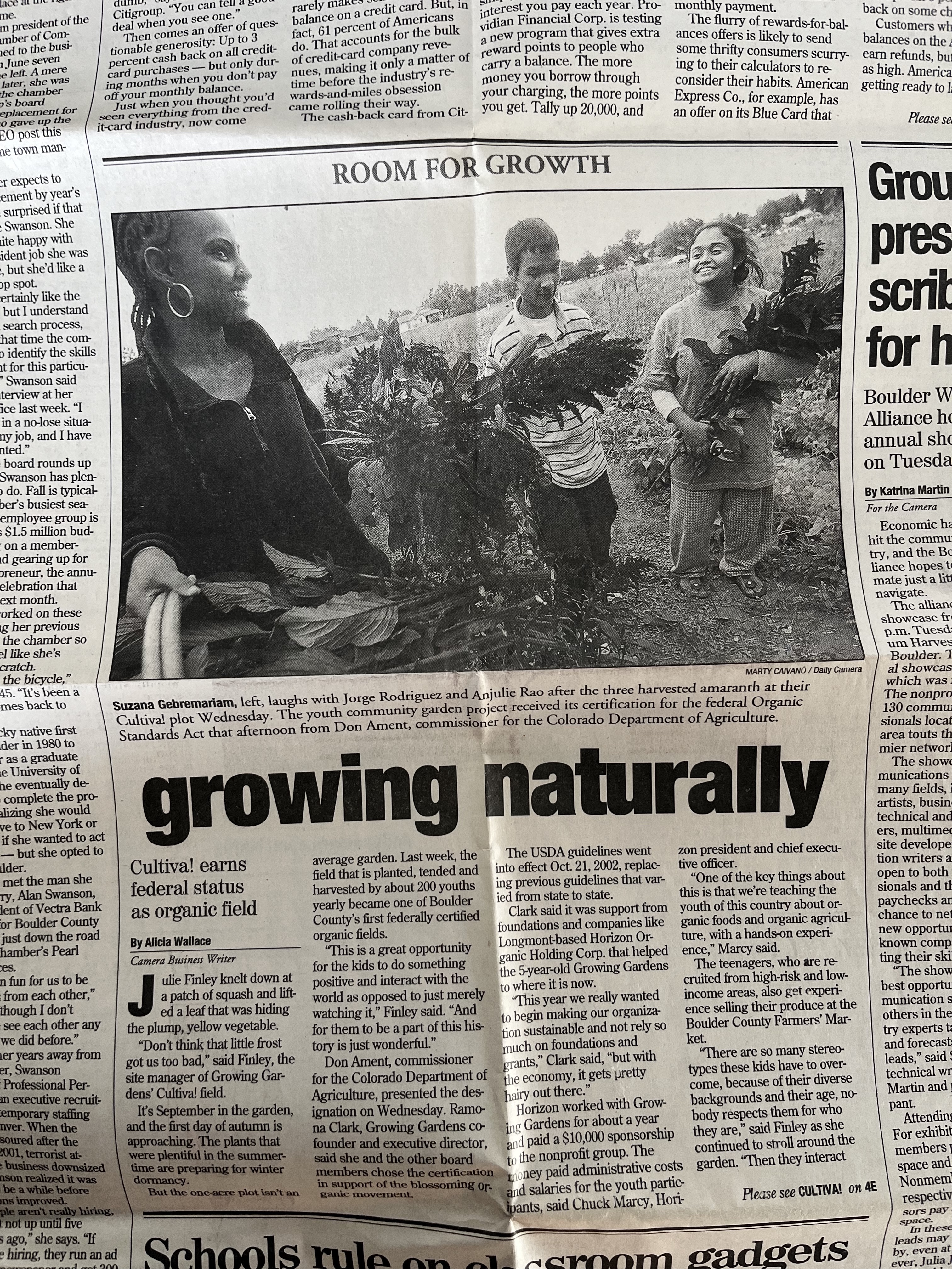 Newspaper article with a black and white photo of author Anjulie Rao working as a teenager in a community garden