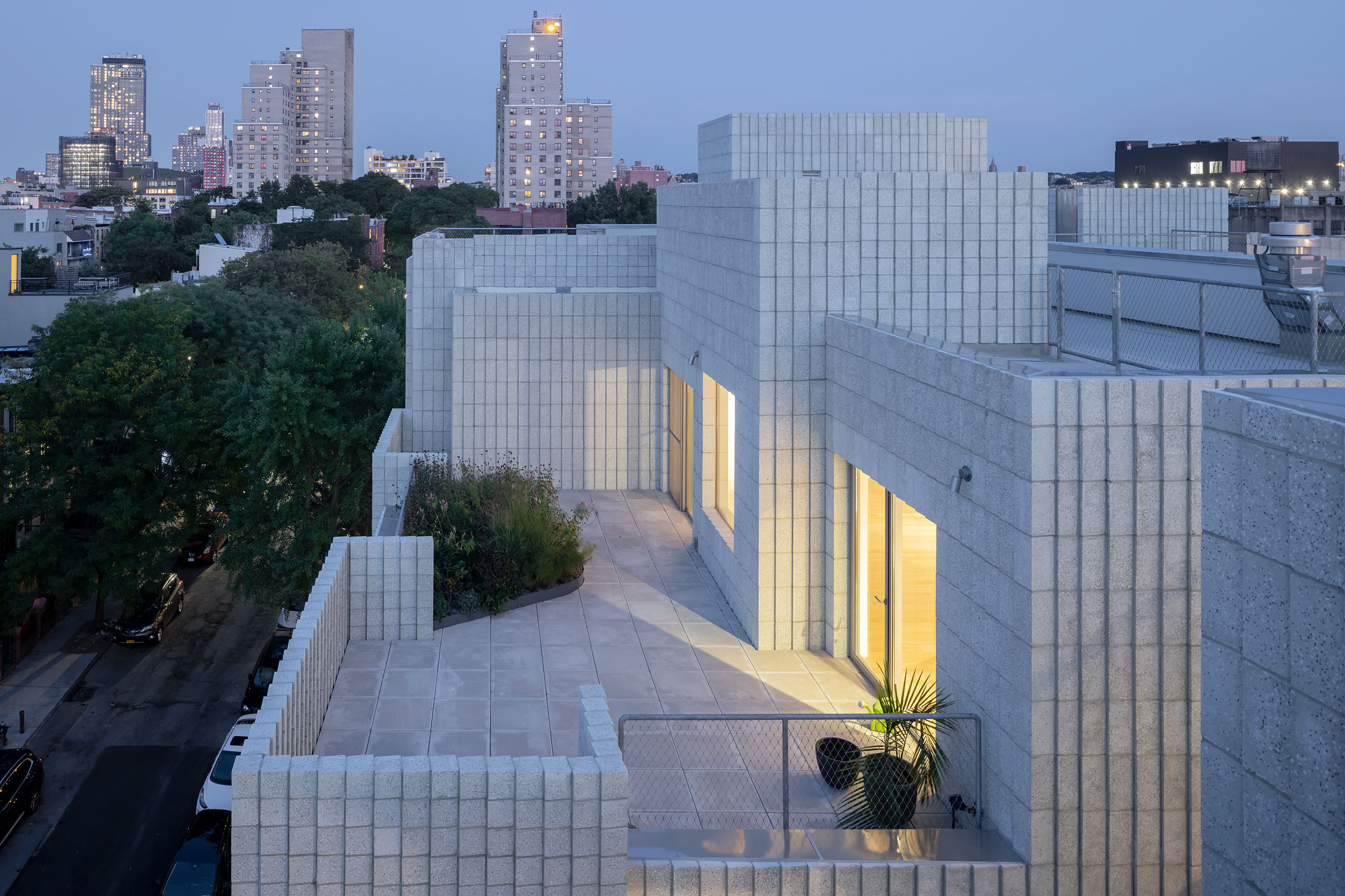 Rooftop patio view of 450 Warren Street at dusk